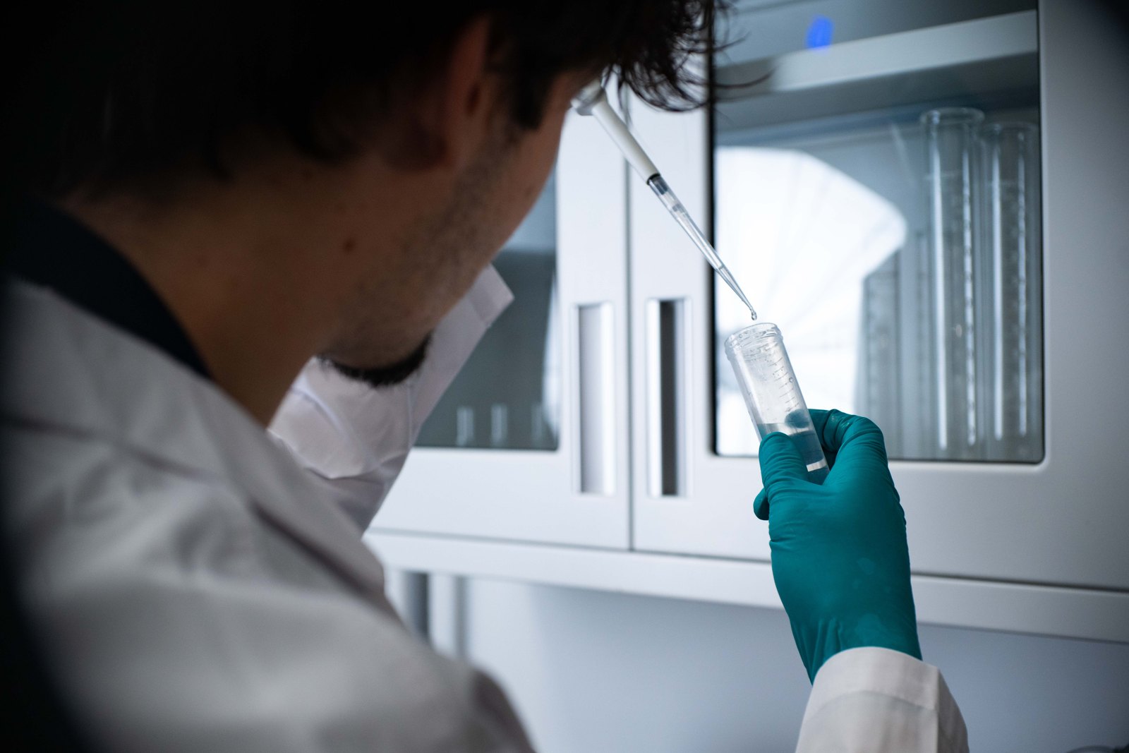 Laboratory researcher examining a clear sample tube