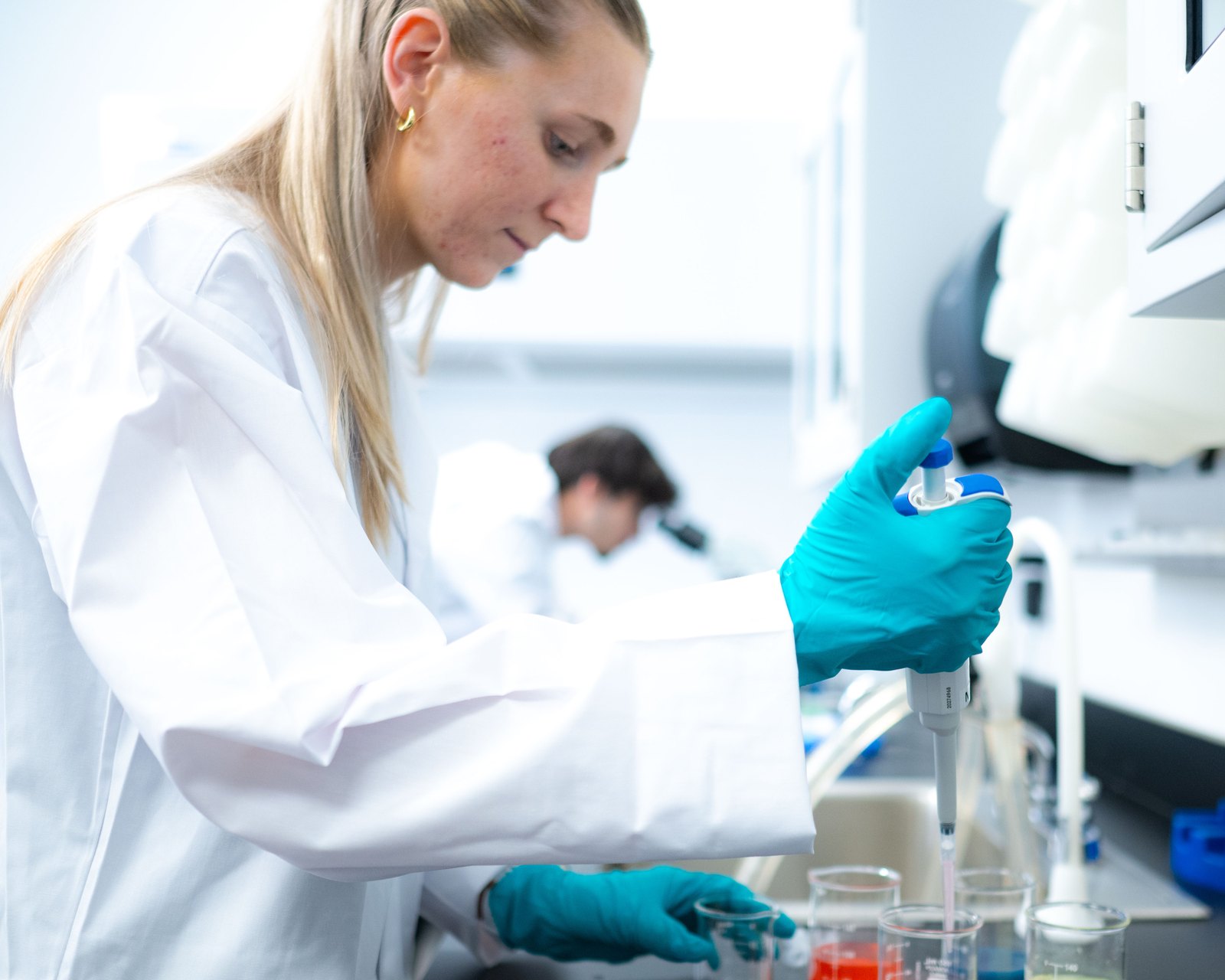 Laboratory researcher using a pipette at a workbench