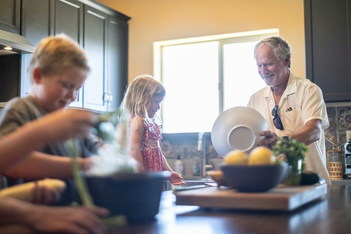A family cooking together in a kitchen